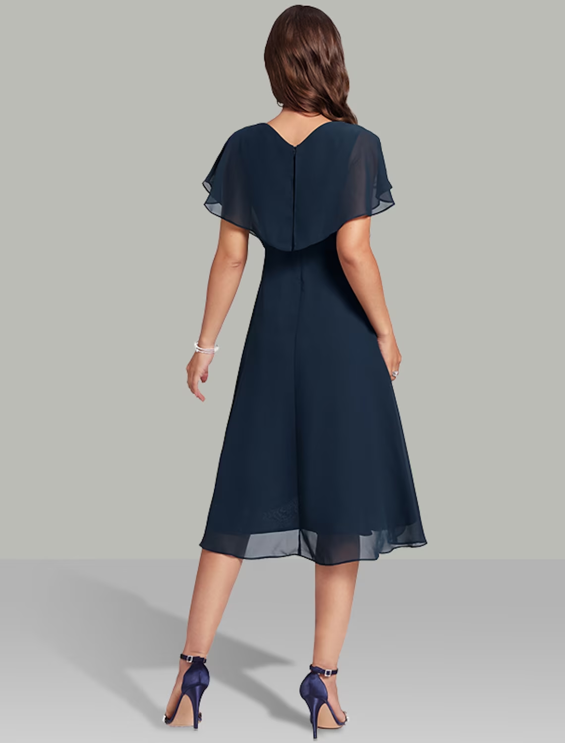 Back view of the A-line chiffon dress, showcasing the tea length and short sleeves.