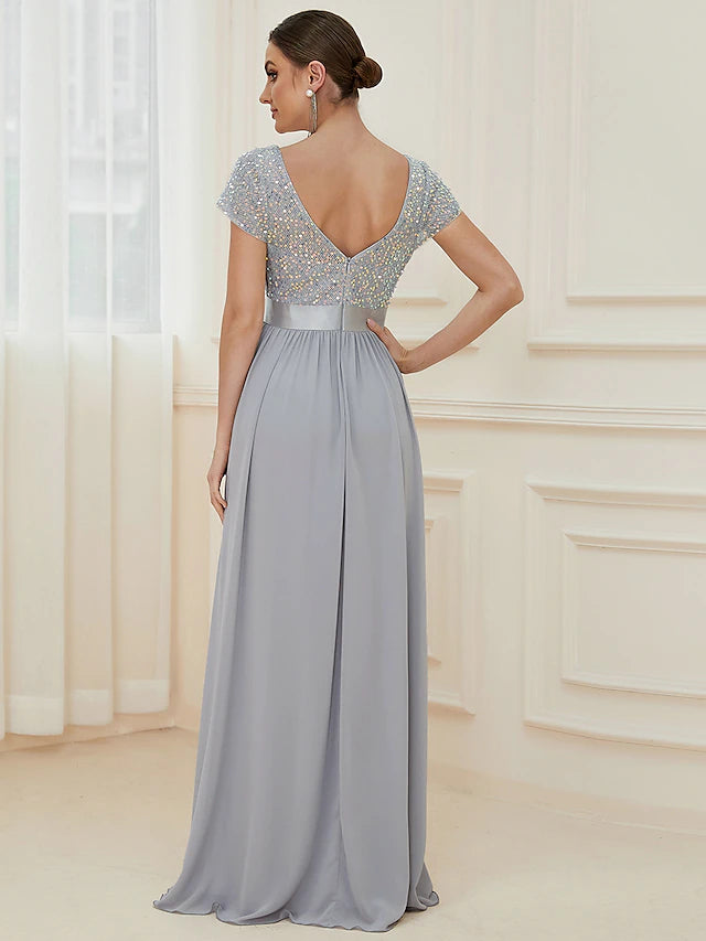Close-up of the V-neckline and short sleeves on a chiffon dress.