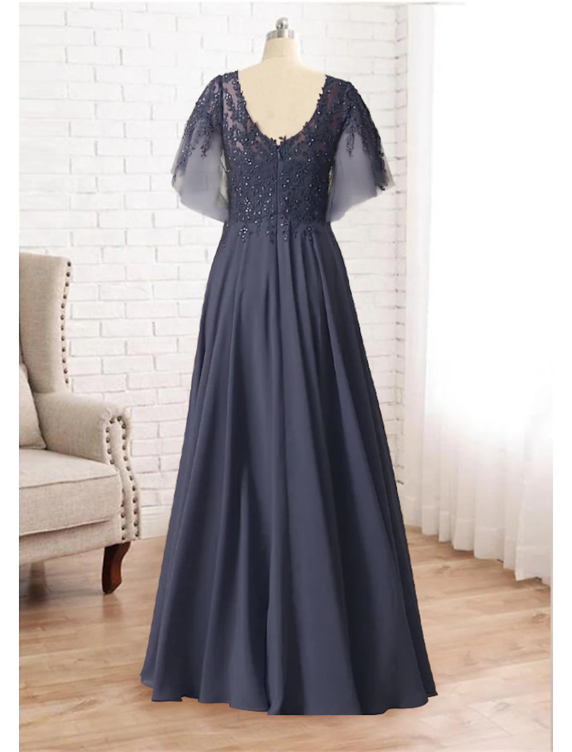 Plus size A-line gown featuring a V-neck, short sleeves, and intricate lace details.