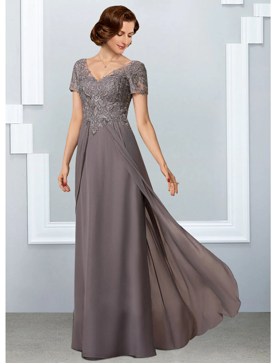 Close-up of the V-neck, short sleeves, and intricate lace appliques on the A-Line gown.