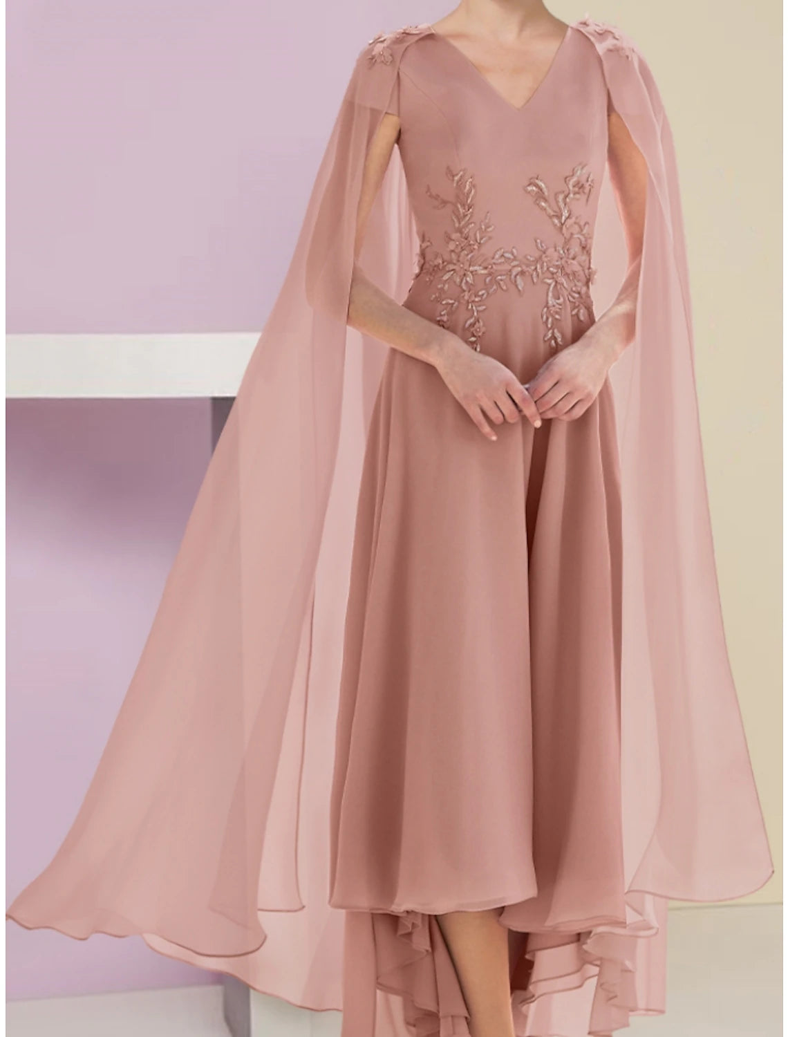 Back view of the A-line mother of the bride dress, showing asymmetrical hem and solid color.