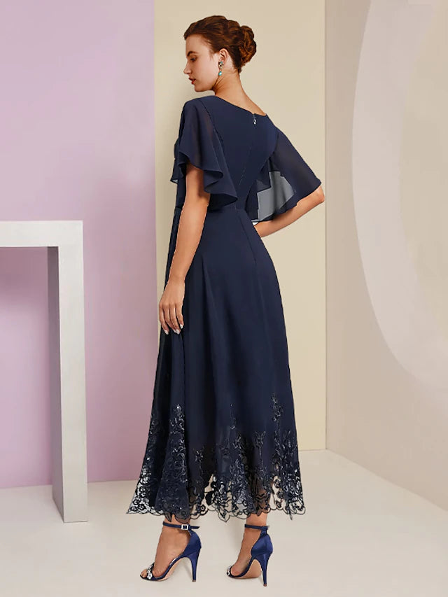 Back view of the elegant V-neck dress, showing the delicate lace and appliques.