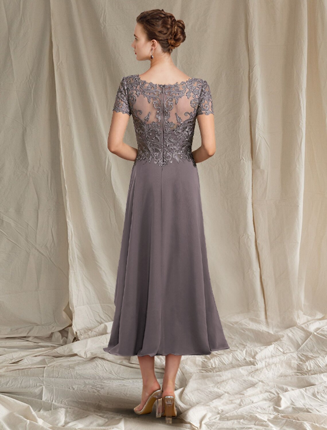 Back view of tea-length chiffon and lace Mother of the Bride gown.