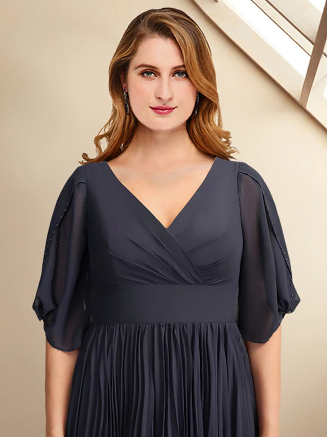 Woman posing in an elegant A-line V-neck short sleeve tea-length chiffon dress with pleats.
