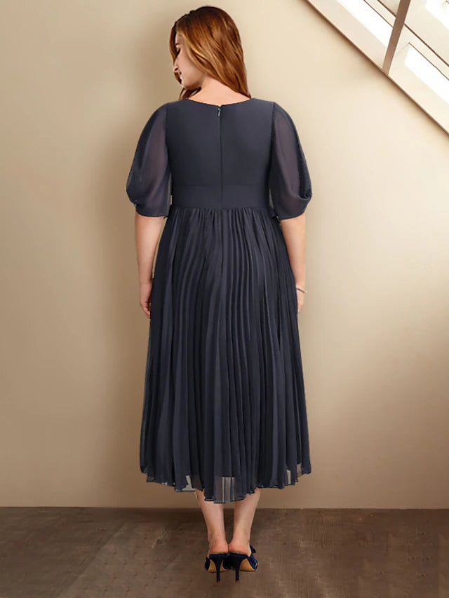 Close-up of the pleated skirt and chiffon fabric of the A-line dress.