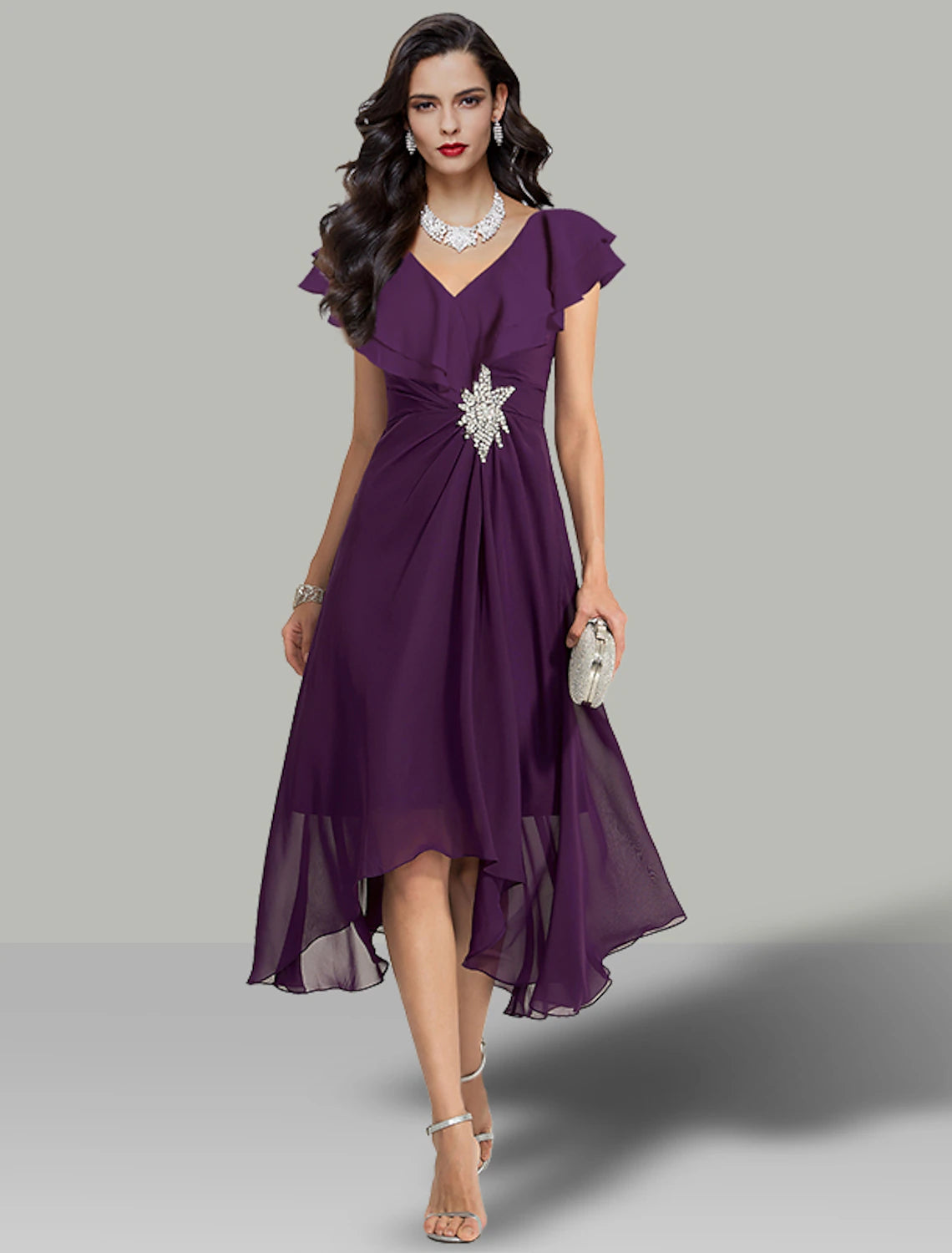 Woman wearing an elegant A-line V-neck short sleeve chiffon tea length dress with rhinestone details.