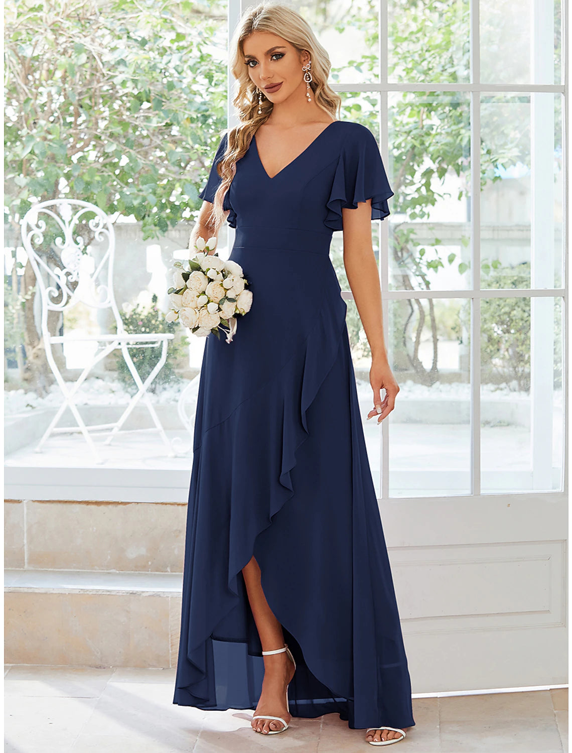 Close-up of V-neckline and ruffle detail on chiffon dress.