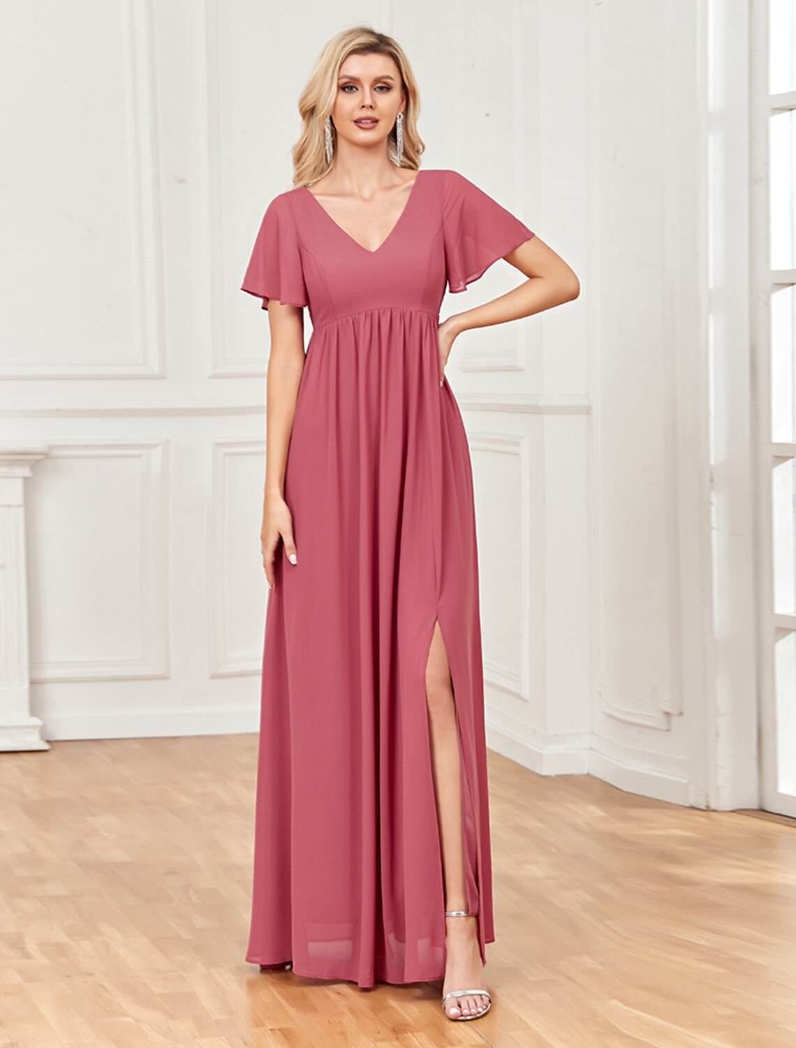 Back view of A-line chiffon gown showing V-back and floor-length slit.