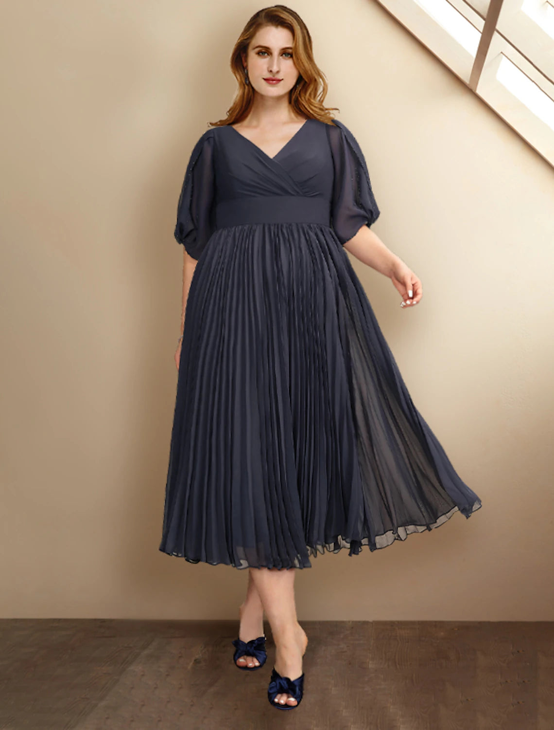 Plus size A-line Mother of the Bride dress in chiffon with V-neck and short sleeves.