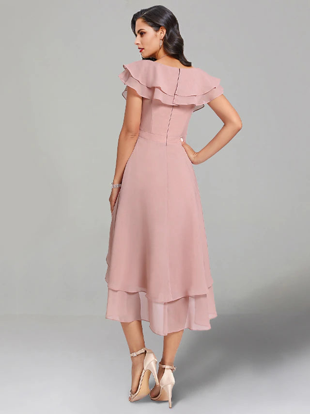 Tea length wedding guest dress in chiffon with a subtle slit.