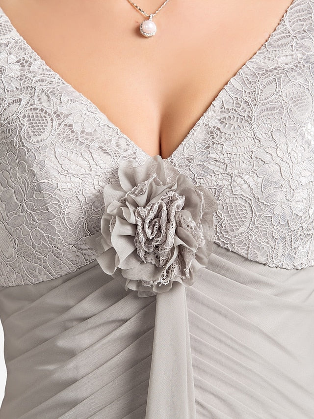 Woman in the floral chiffon lace dress, showing the asymmetrical design and elegant silhouette.