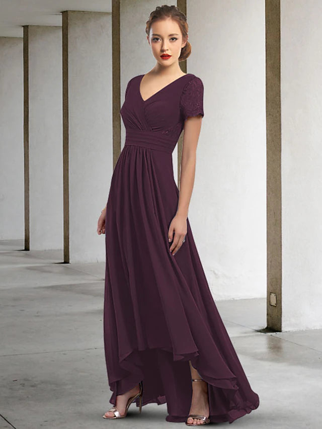 Back view of an A-line chiffon dress showing ruched details and asymmetrical hem.