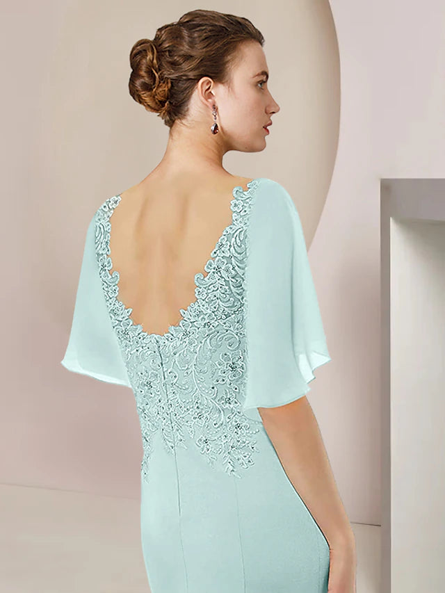 Back view of A-Line tea length dress showing high-low hem and lace details.