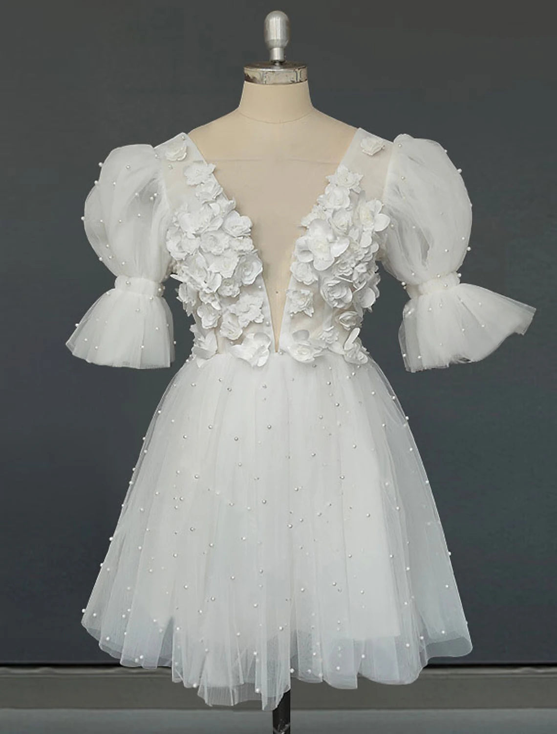 Front view of white A-Line V-Neck mini bridal dress with short sleeves and pleats.