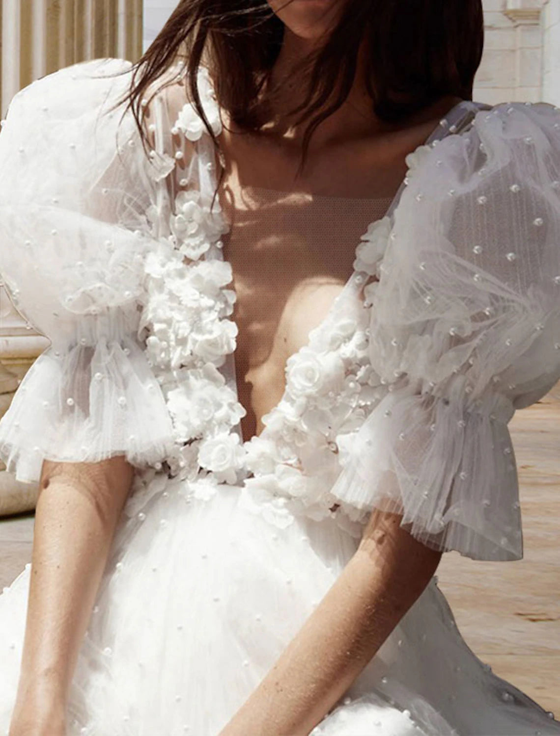 Close-up of the V-Neck and short sleeve details on the white bridal dress.