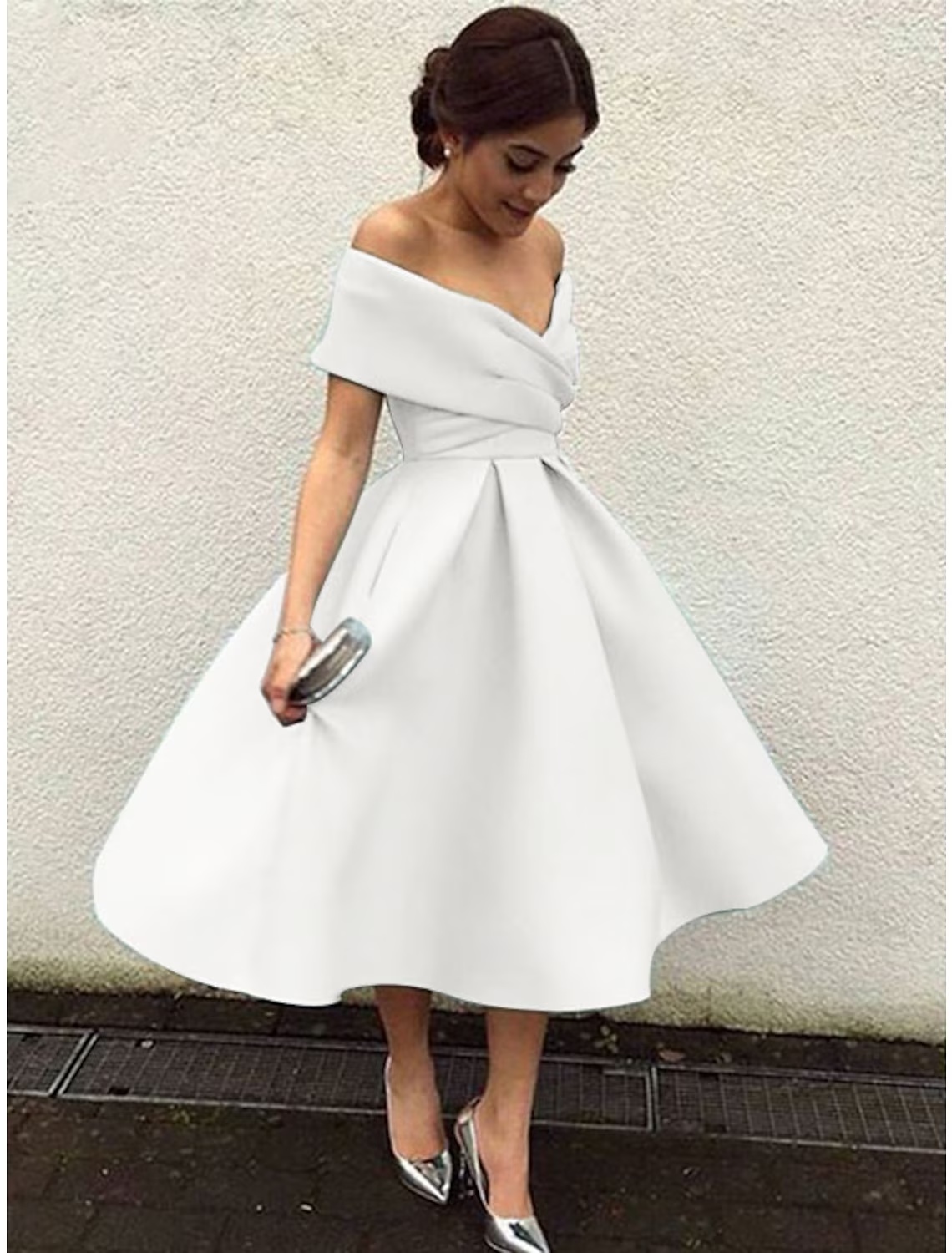 Full length view of the A-line pleated tea length dress.