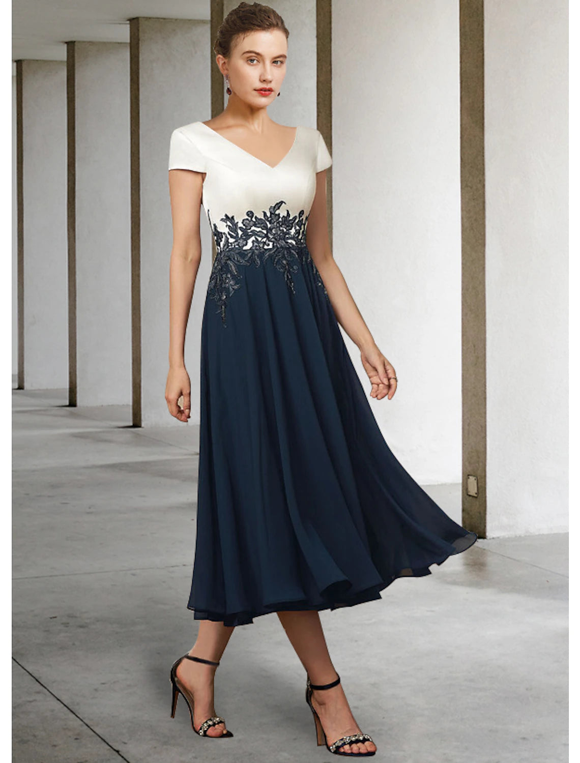 Back view of elegant tea length dress with delicate lace appliques.
