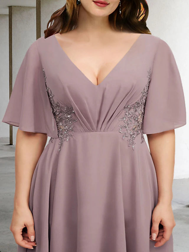 Side profile of the asymmetrical plus size dress, highlighting the flowing chiffon.