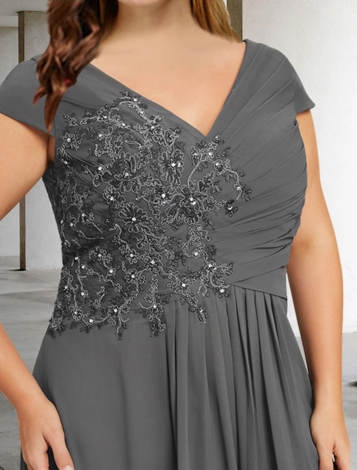 Back view of the formal floor-length dress, highlighting the elegant drape.