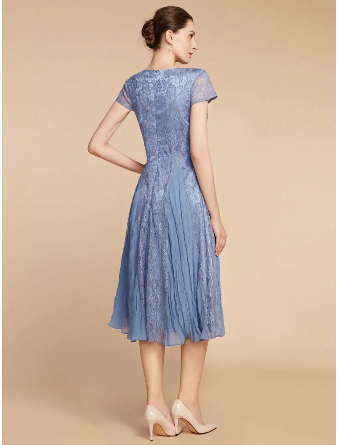 Back view of the A-line knee-length dress, showing solid color fabric.