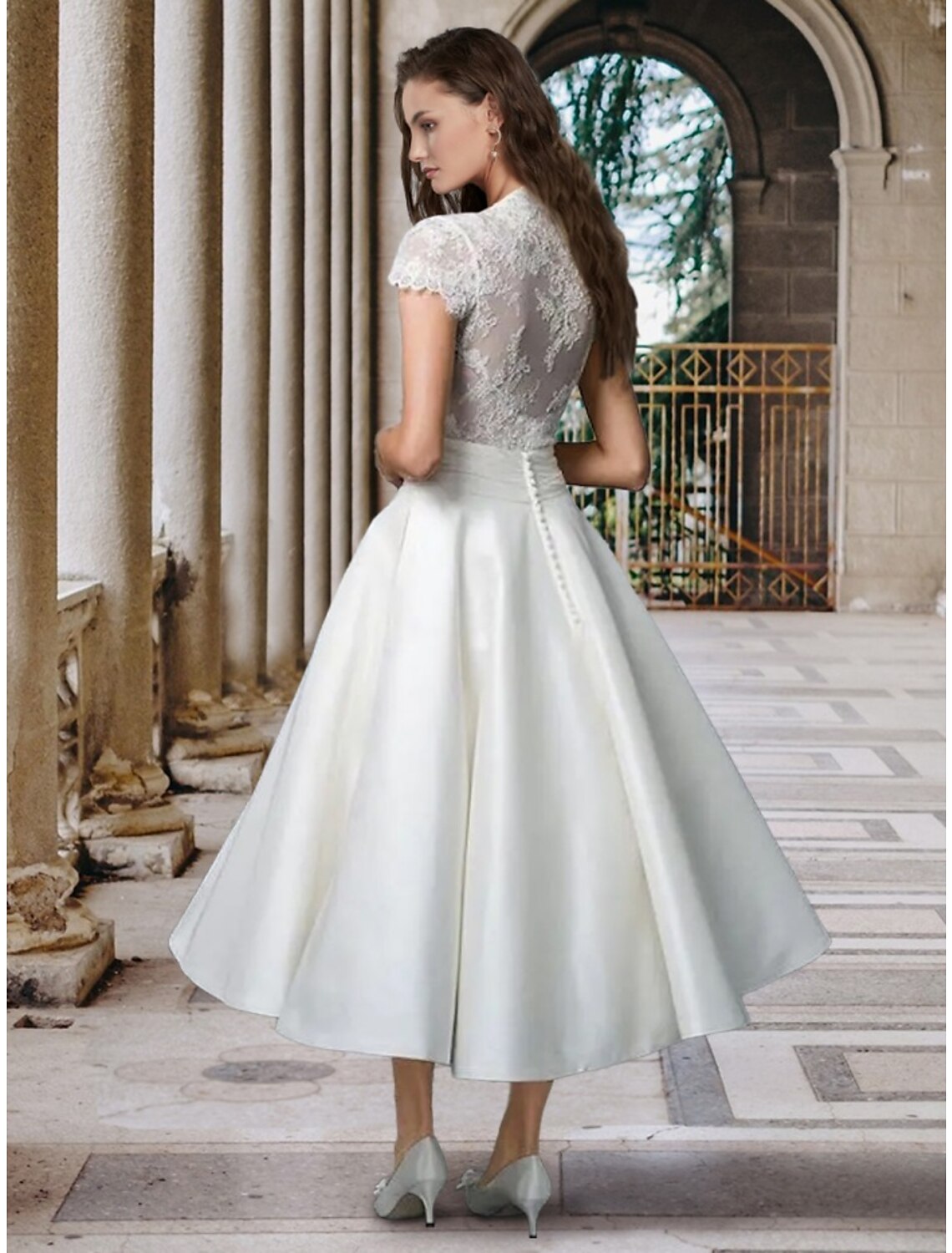 Back view of the A-line V-neck short sleeve satin tea length bridal gown, showcasing pleats.