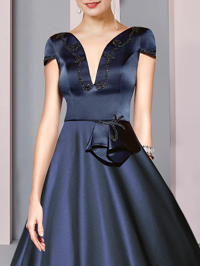 A-line V-neck satin tea length Mother of Bride dress, showcasing back details and ruching.
