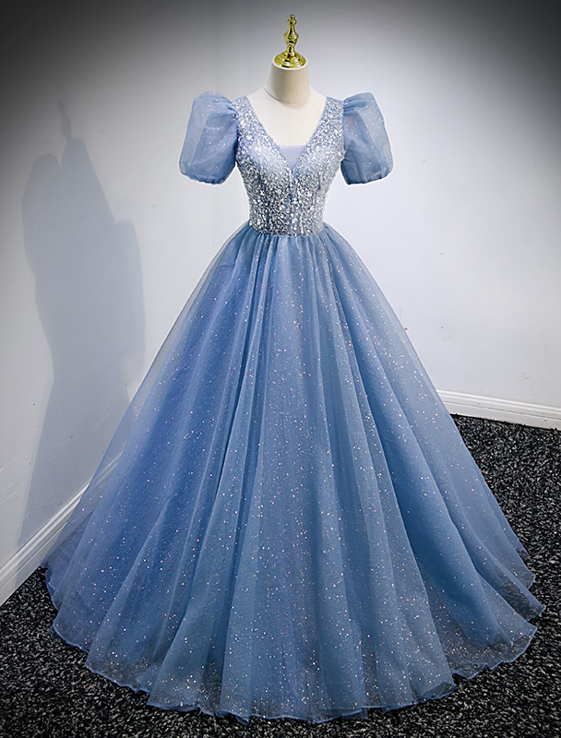 Woman in elegant A-line V-neck short sleeve sequin tulle prom gown.