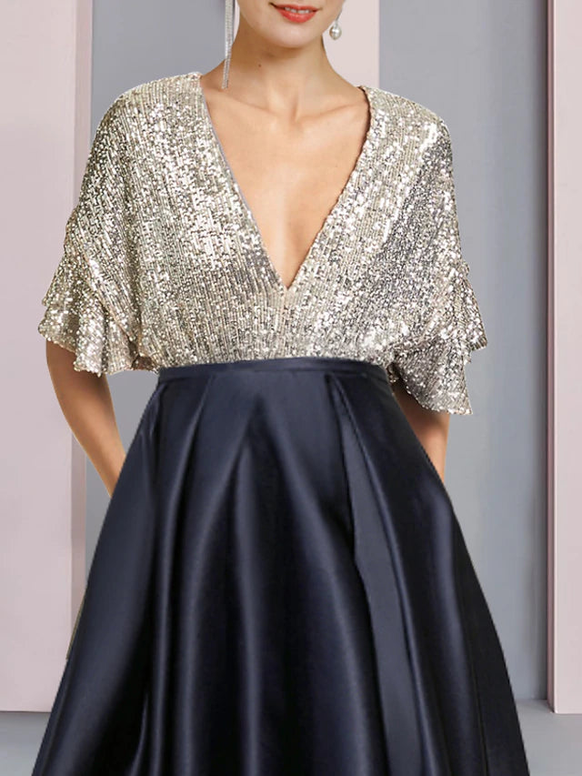 Back view of the sequined satin A-Line dress, showing high-low tea length hem.
