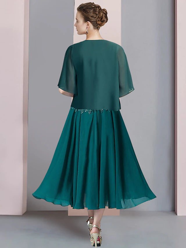 Back view of the tea-length chiffon and lace dress with sequin details.