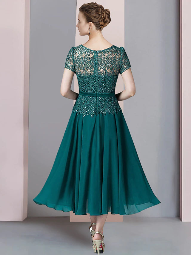 Full view of the two-piece dress with included wrap, suitable for wedding guests.