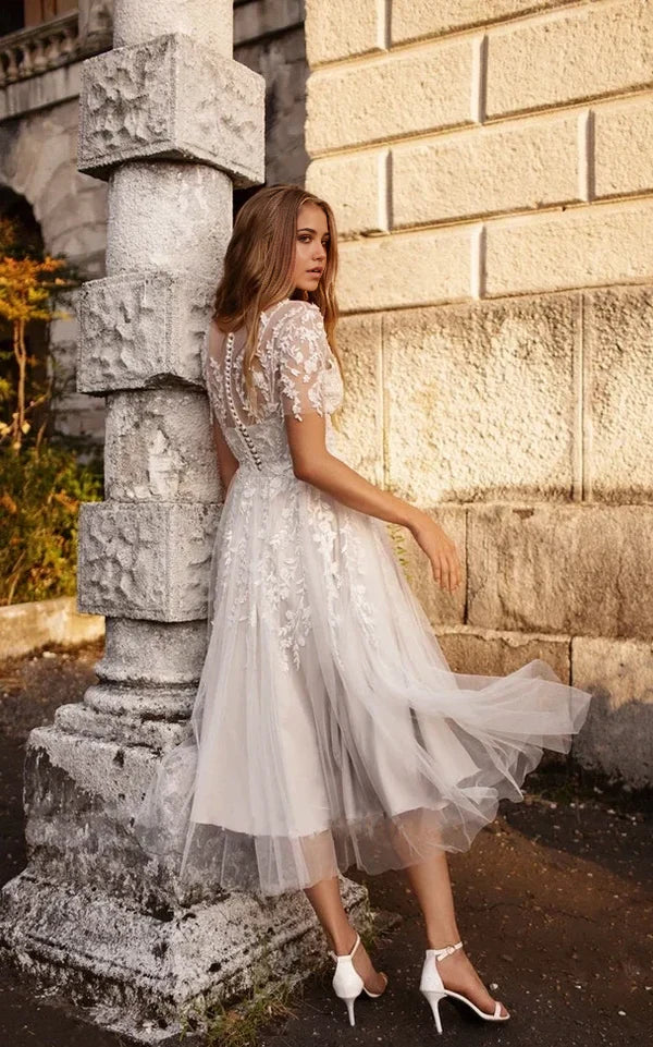 Front view of the tea length bridal gown with short sleeves.