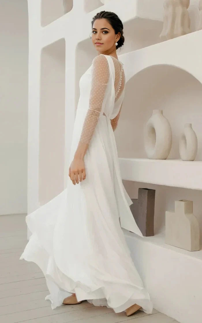 Bridal gown featuring V-neck, long sleeves, and flowing chiffon skirt.