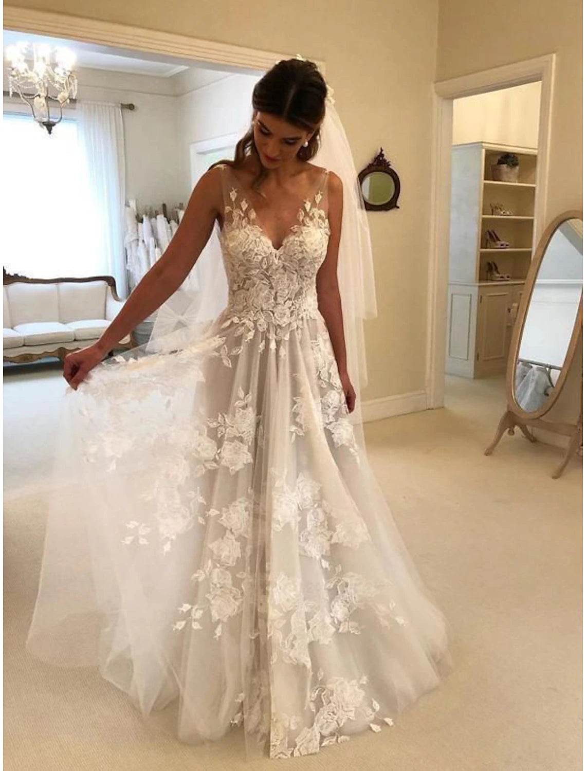 Full view of the A-line V-neck sleeveless boho lace wedding dress with sweep train.