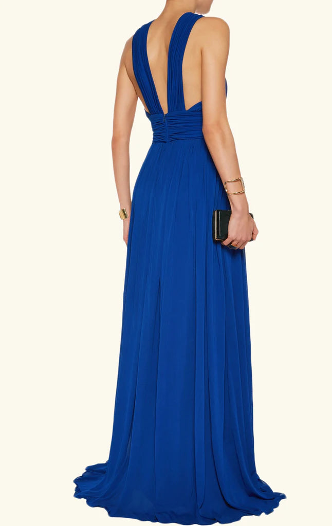 Back view of a woman in a long chiffon evening dress.