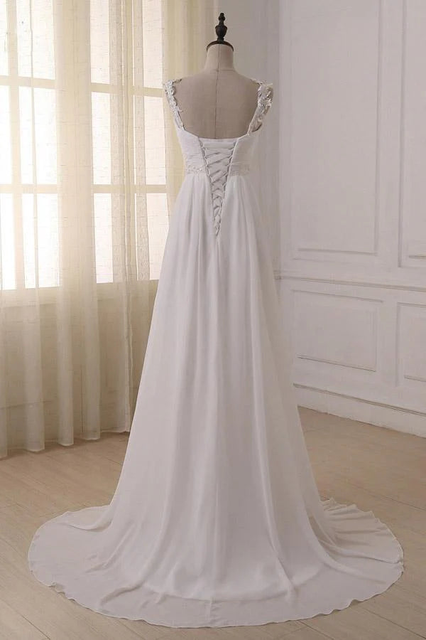 Back view of a simple chiffon wedding dress with a long sweep train.