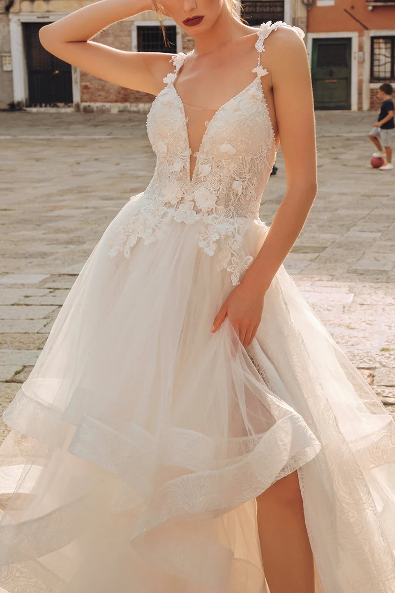 Elegant A-line V-neck wedding dress with lace appliques.