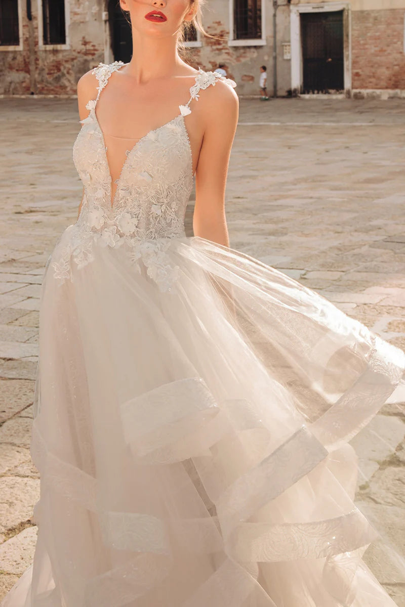 Close-up of lace appliques on A-line wedding dress.