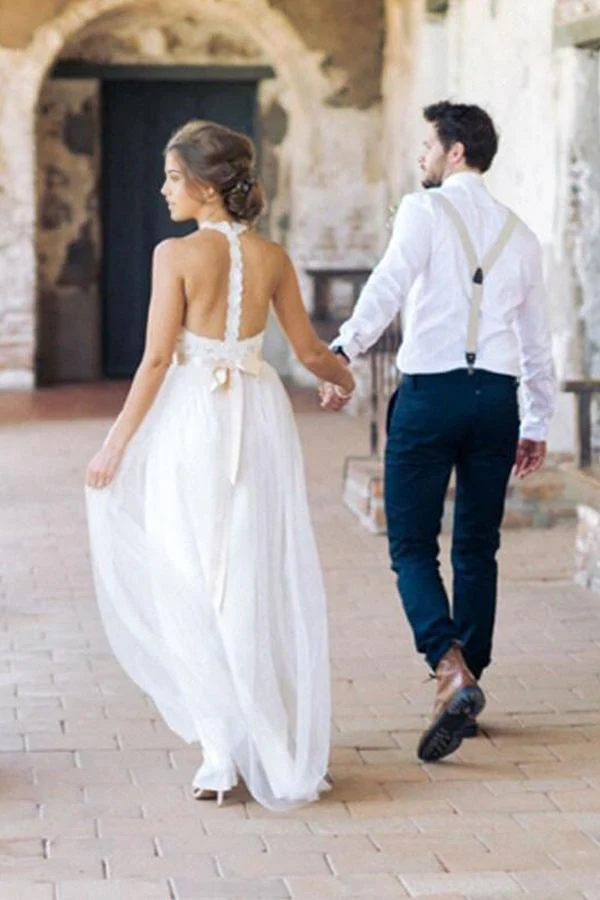 Bride wearing a sleeveless floor-length wedding gown.