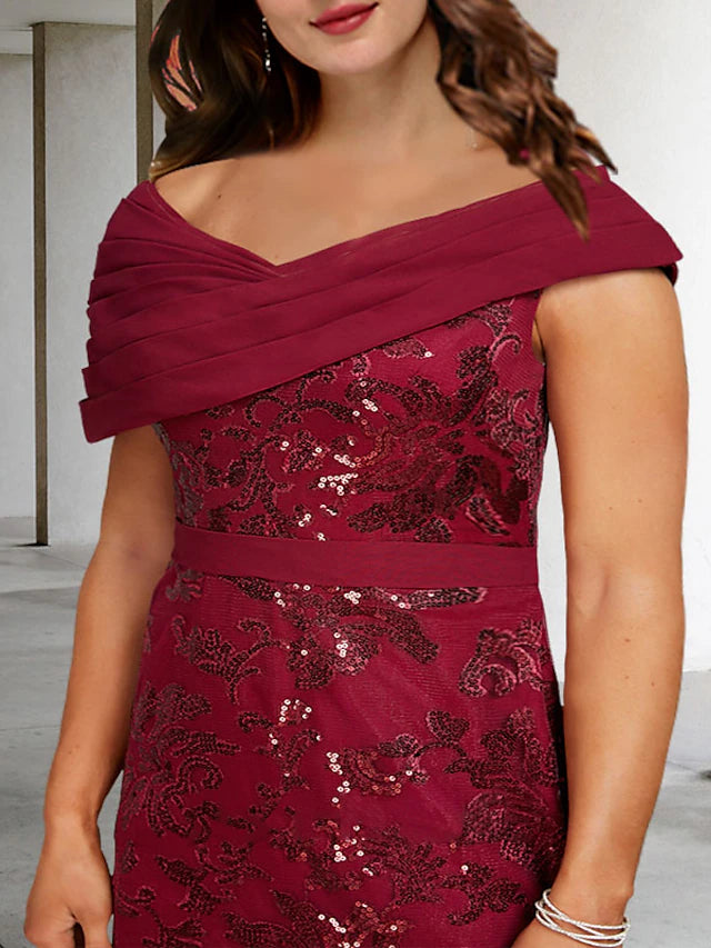 Back view of a floor-length A-line plus size formal gown with delicate lace and sequin details.