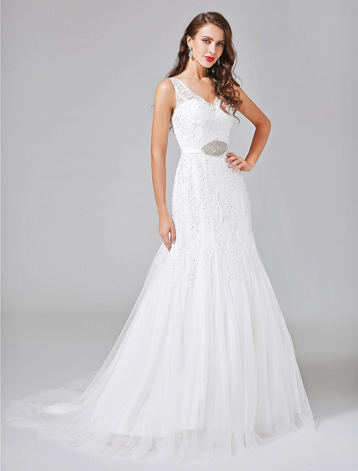 Full view of an A-line V-neck lace wedding dress with a court train.