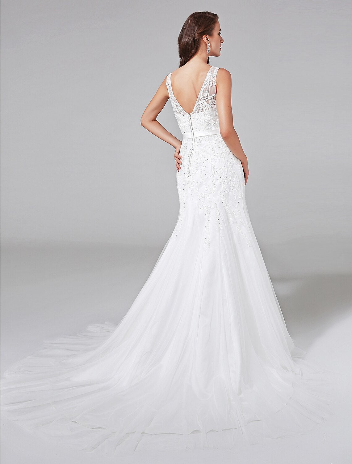 Close-up of the lace detailing and V-neckline on the bridal gown.