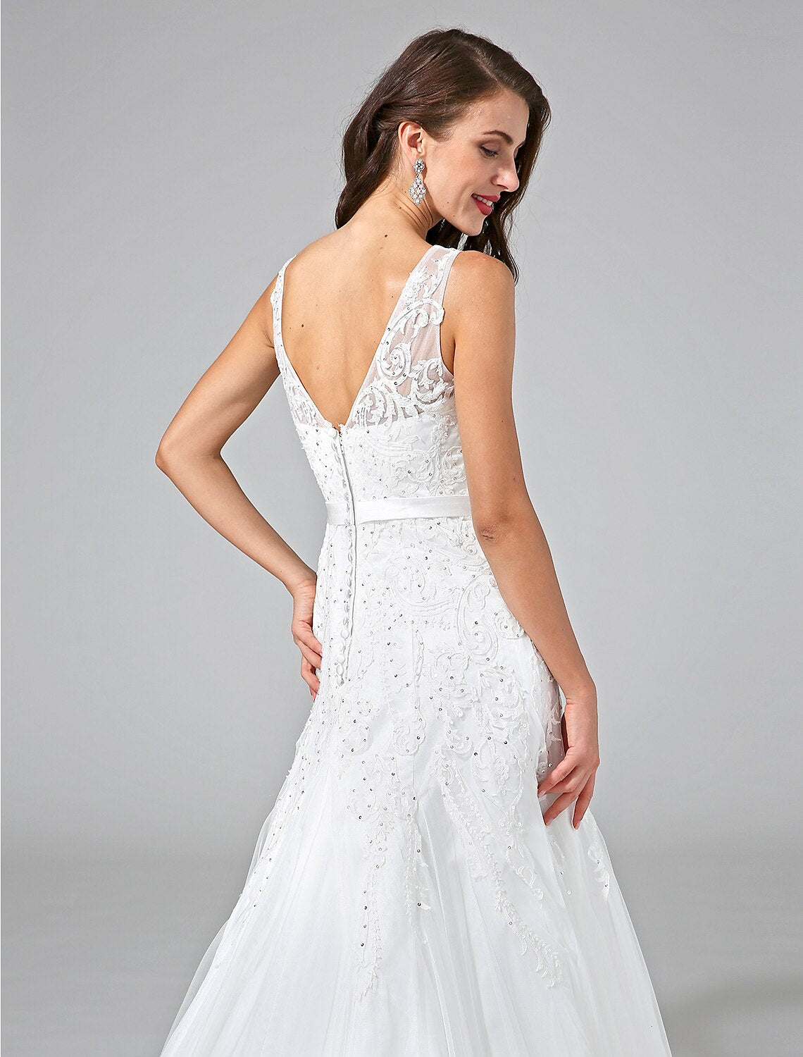Side view of the A-line wedding dress with beading and ribbon.