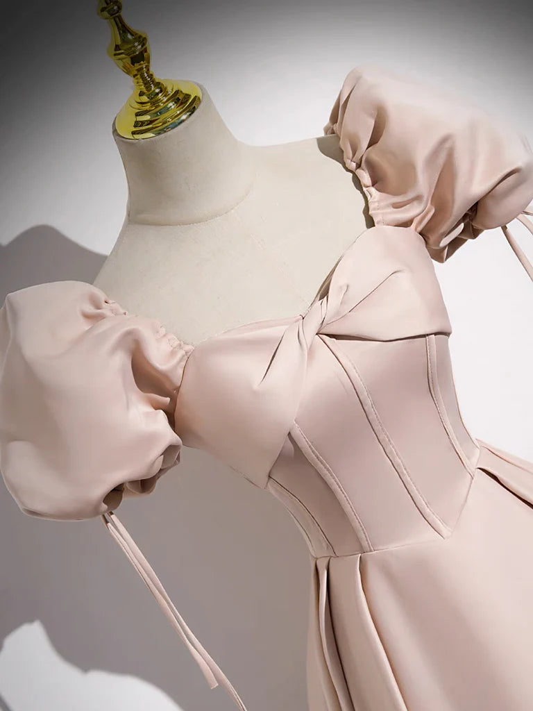 Model showcasing the flowing light blue satin prom dress.