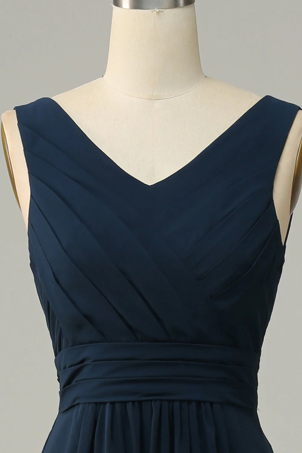 Close-up detail of the fabric and V-neckline on a navy bridesmaid dress.