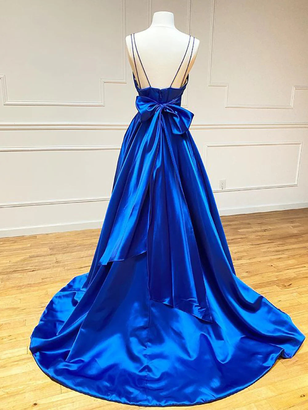 Woman wearing a flowing A-line V-neck long formal dress.