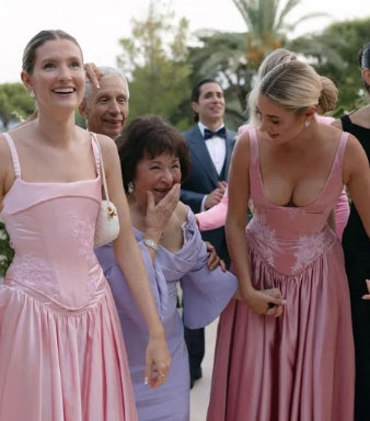 Back view of a sleeveless pink satin formal dress.