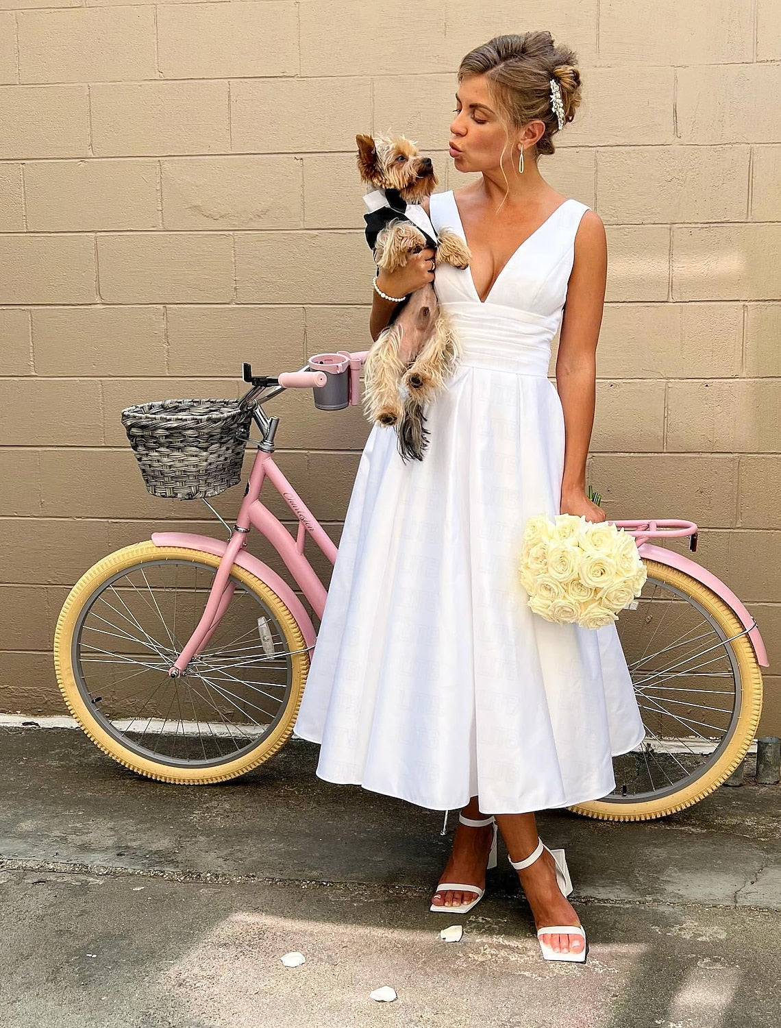 Elegant A-line V-neck sleeveless white satin tea length wedding dress with ruched details.