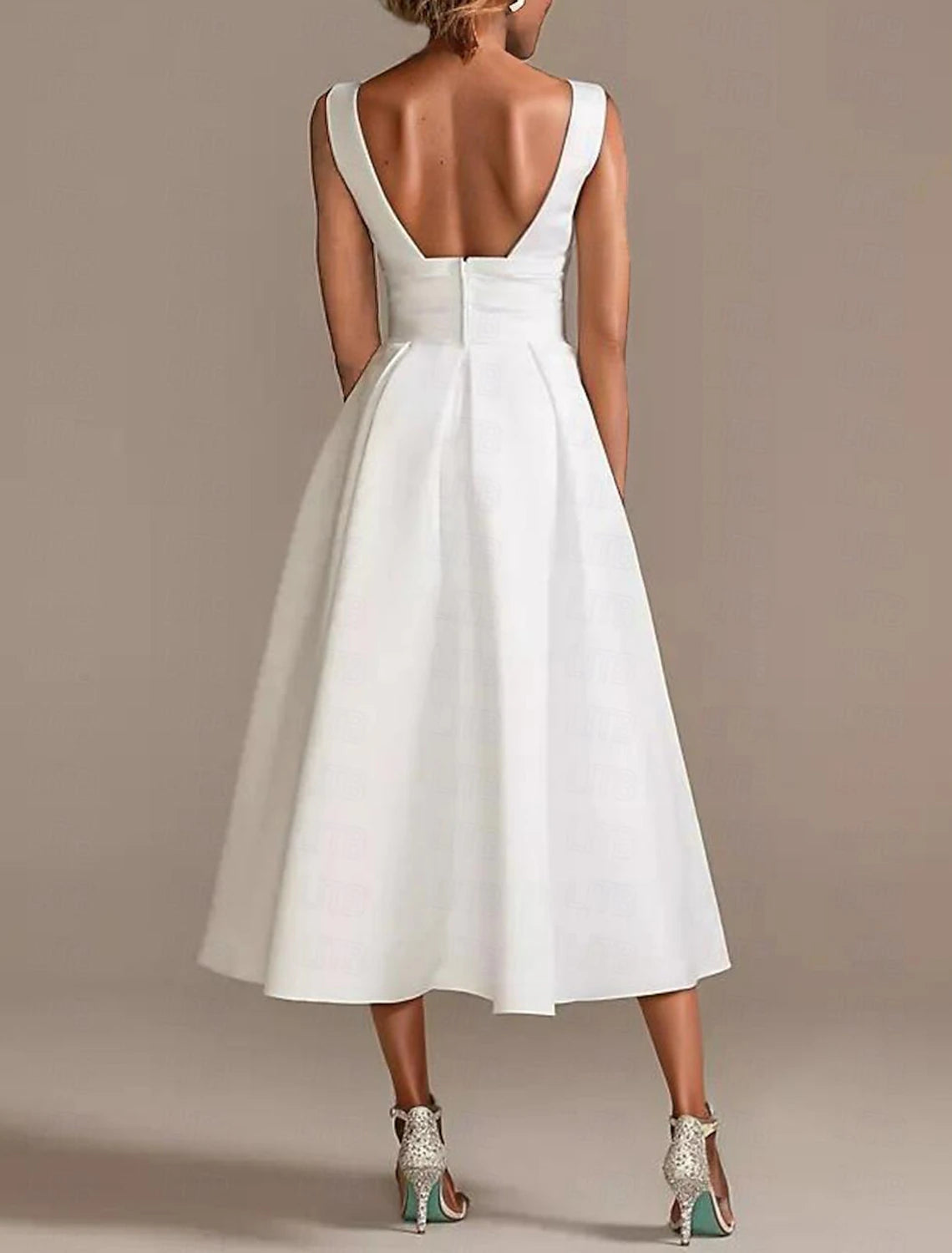 Side view of a white satin A-line V-neck sleeveless bridal gown with delicate ruching.