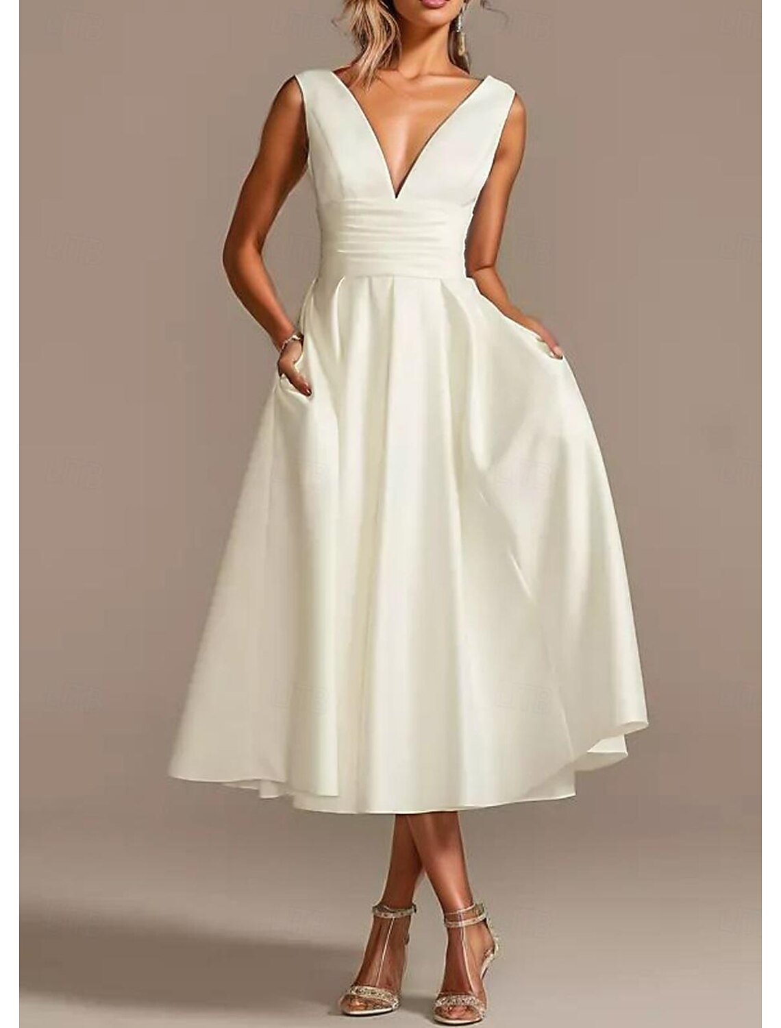 Model wearing the A-line V-neck sleeveless white satin tea length wedding dress.