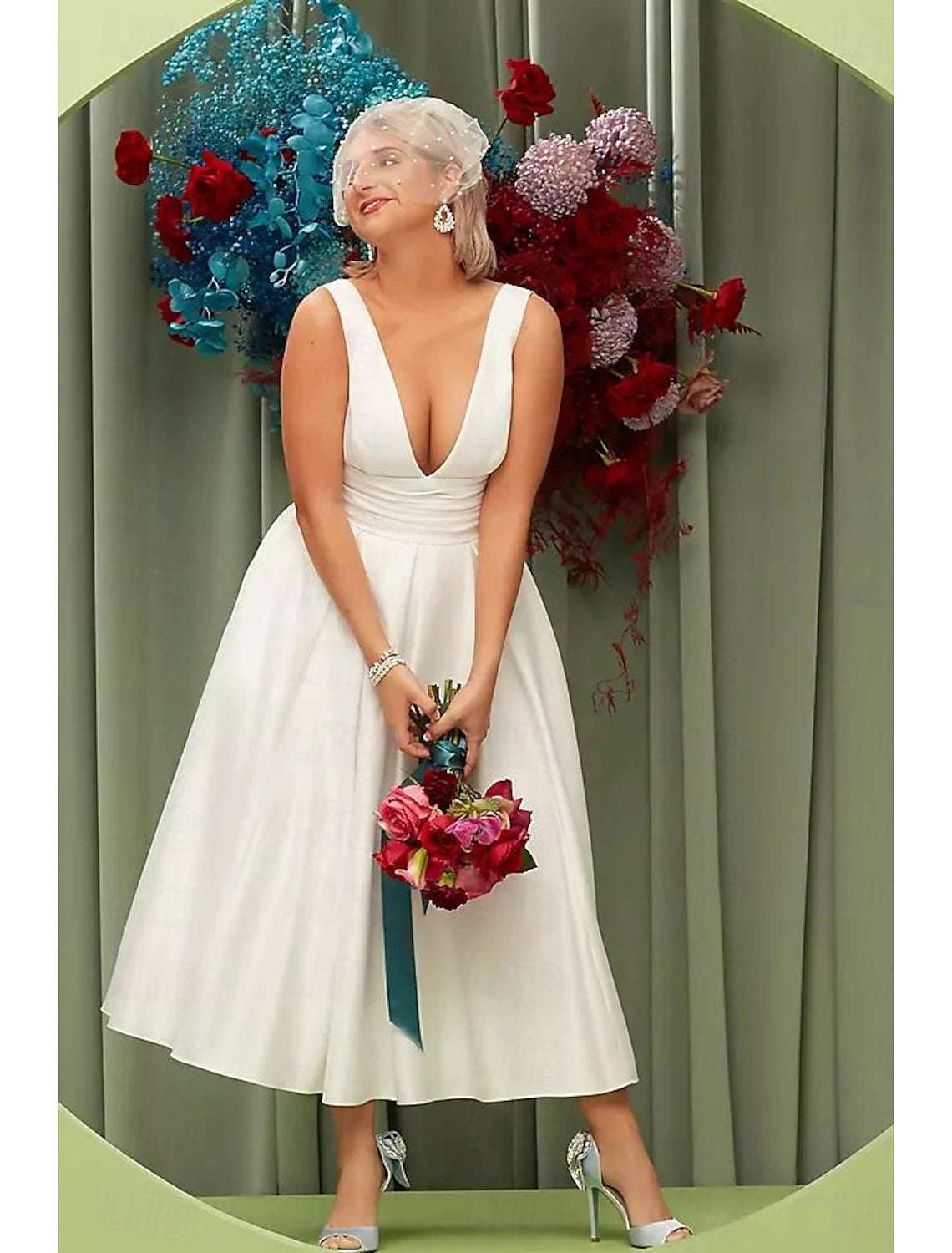 Full length view of the elegant white satin bridal gown with ruched details.